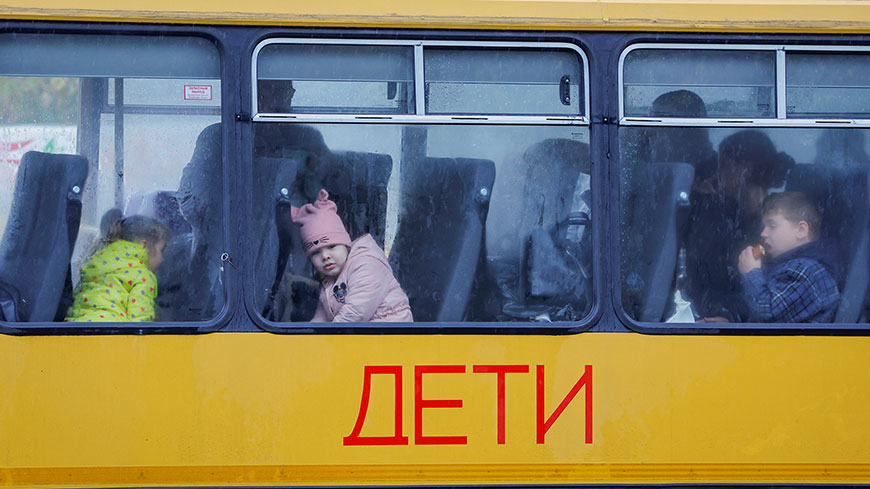 Children evacuated from the then Russian-controlled city of Kherson, wait in a bus heading to Crimea, in the town of Oleshky, Kherson region, Ukraine October 23, 2022. REUTERS/Alexander Ermochenko