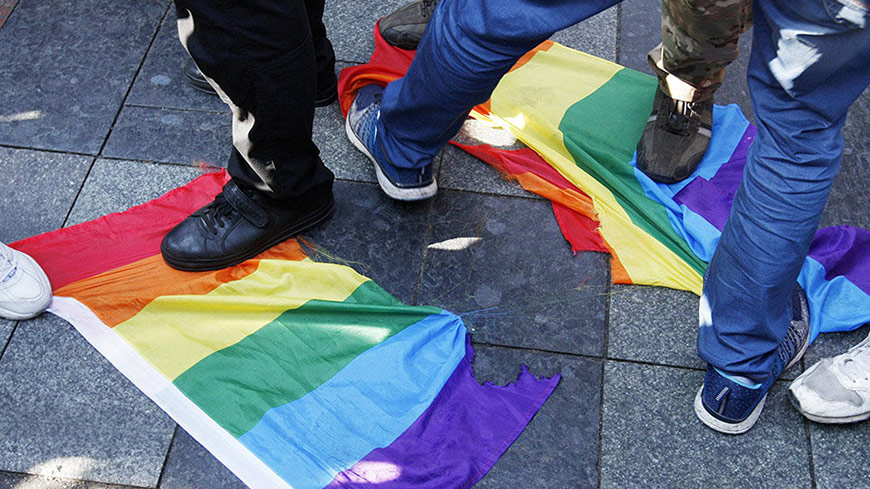 Anti-LGBT protestors stamping on the LGBT flag during the Pride parade 2017 in Kiev, Ukraine